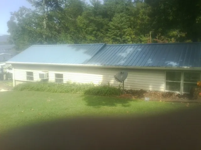 Blue metal roof running the length of a single story home in Cedar Springs